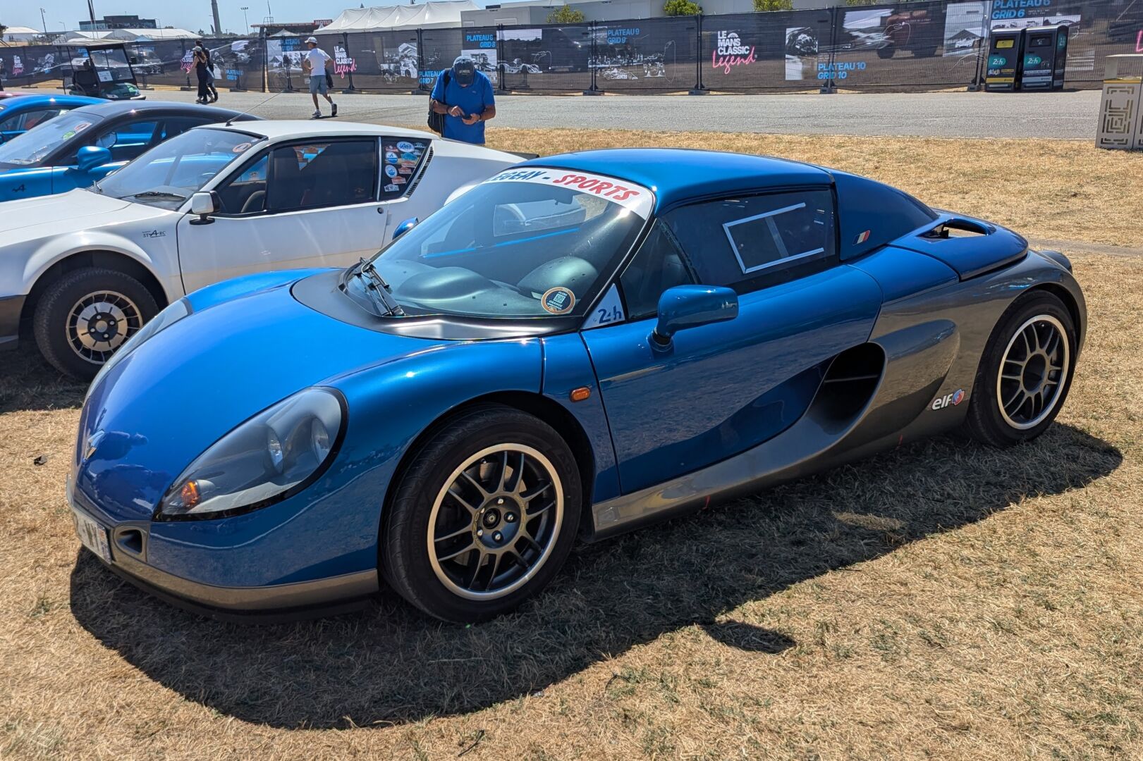 Blue and silver Renault Sport Spider with a hard top at Le Mans Classic Legend.