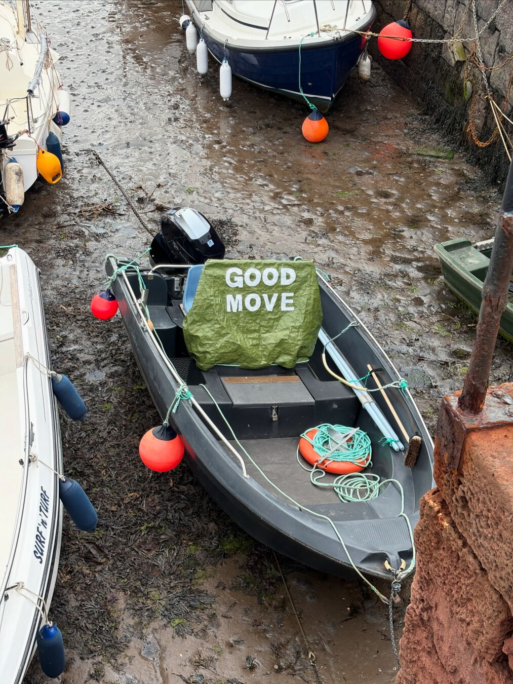 Dinghy with cover which has the wording "GOOD MOVE" printed in white on an avocado green background.