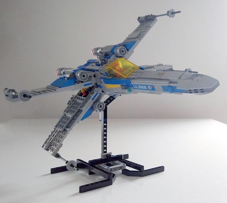 An X-Wing from Star Wars movie recreated with LEGO bricks in a minifigure scale and using a classic Space Lego colour scheme.