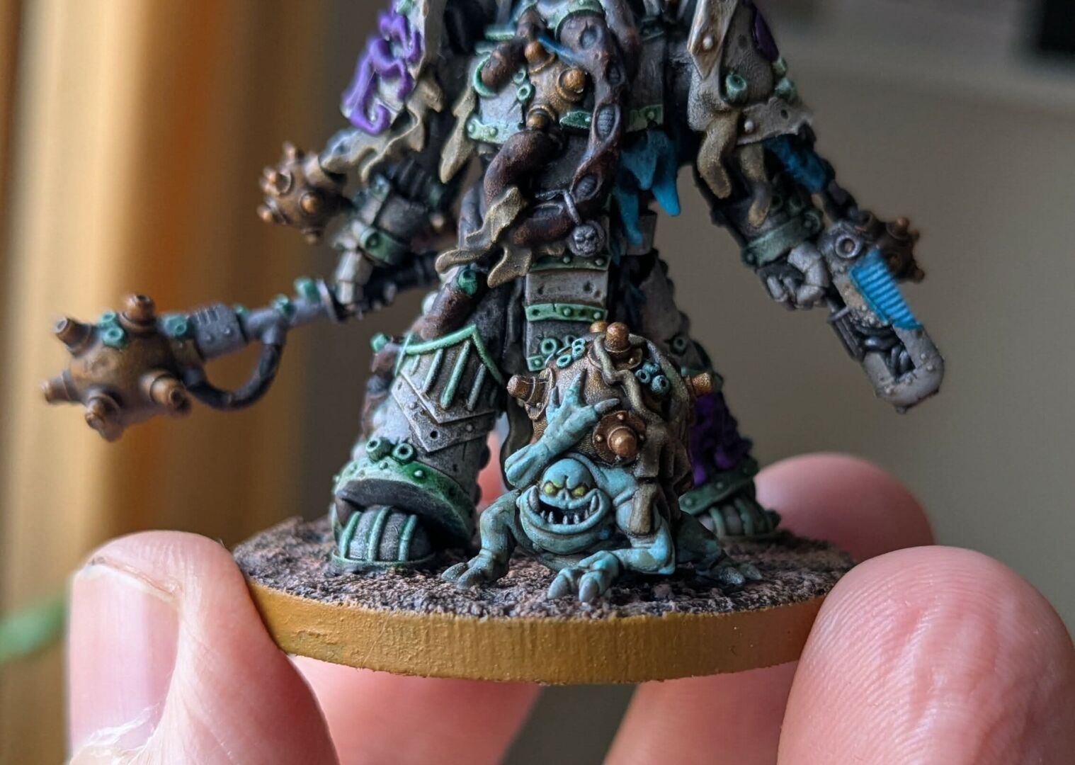 A close-up of the dredgeling carrying a mine. Its skin is an uncomfortable colour of pale turquoise.