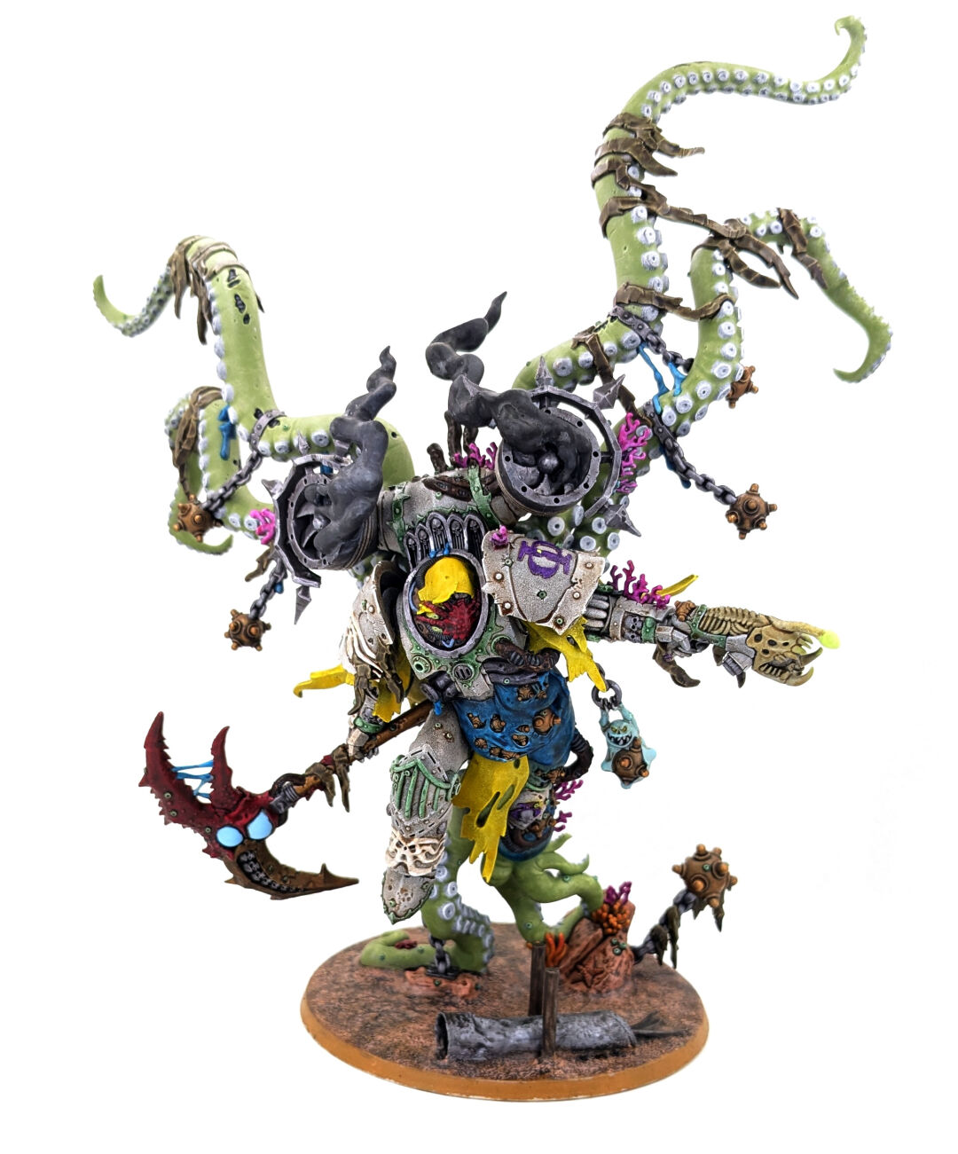 A large, painted wargaming miniature. A mutated figure who was clearly originally a power armoured super soldier but seems to have grown in scale at least 500%, sprouted many tentacles, and has some sort of tentacle-based jump pack. He also looks like he's lived under the sea for an extended period.